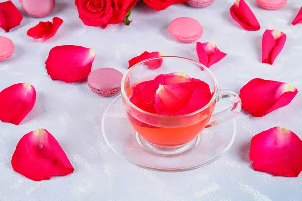 tea made from tea rose petals in a glass bowl on grey table.