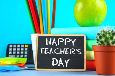 Bir kara tahta üzerinde metin tebeşir: mutlu öğretmenin gün. Okul malzemeleri, ofis, kitaplar, elma.