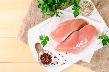 ahşap kesme tahtası üzerinde çiğ tavuk fileto.