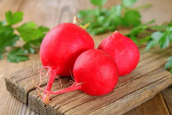 Fresh young radish on wooden old table boards — Stock Photo, Image