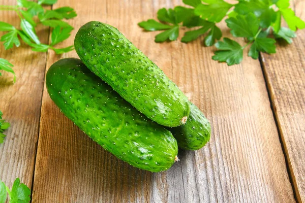 Fresh green homemade cucumber with parsley on an old wooden tabl — Stock Photo, Image
