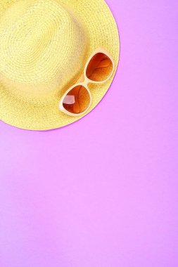 Şapka, güneş gözlüğü, pastel pembe, mor arka plan.