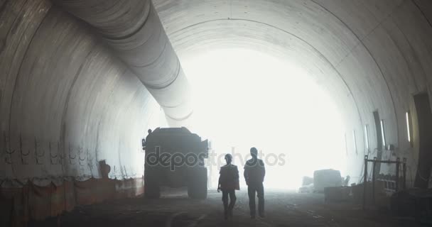 Construction workers inside a large tunnel under construction — Stock Video