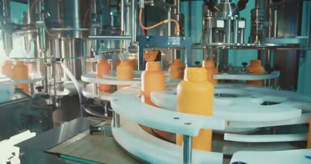 Machines in an automated chemical bottles production line — Stock Video