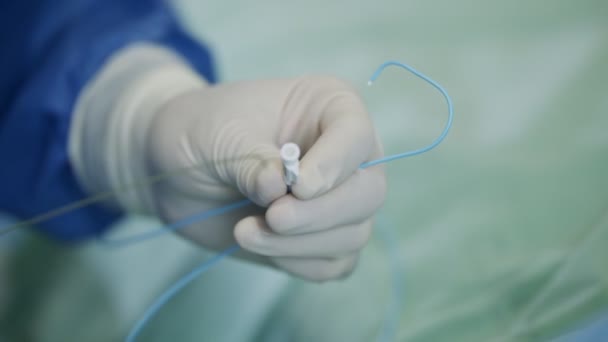 Close up on Surgeon hand during a heart catheterization — Stock Video