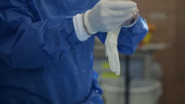 Slow motion of surgeon wearing surgical gloves before surgery — Stock Video