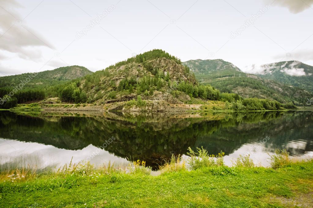 Summer Norwegian mountain landscape reflected in water