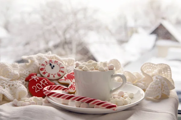 white Cup of cocoa on a saucer, marshmallows and candy