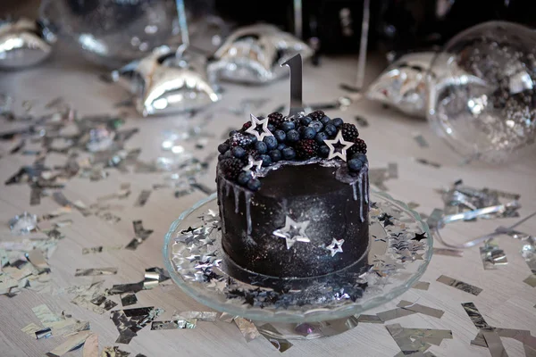 black cake with stars and berries