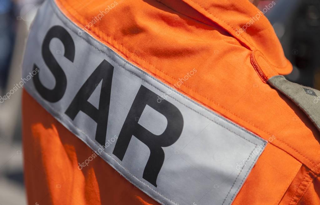 BERLIN / GERMANY - JUNE 3, 2016: SAR ( Search and Rescue ) logo on a pilot from a  rescue helicopter. SAR is the search for and provision of aid to people who are in distress or imminent danger.