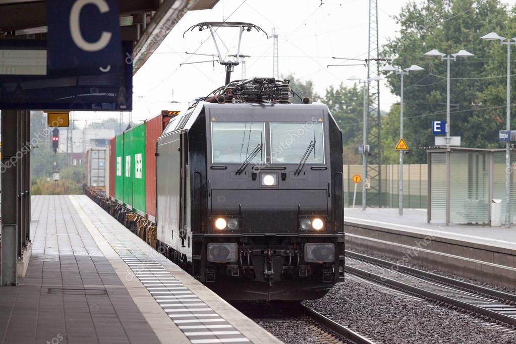 a black german good train on station