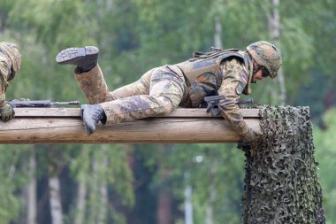 BURG / GERMANY - JUNE 25, 2016: german soldier with hk g 36 rifle on assault course , at open day in barrack burg clipart