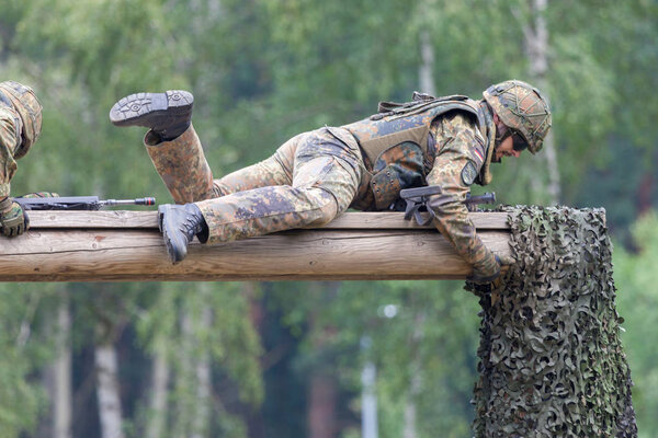 BURG / GERMANY - JUNE 25, 2016: german soldier with hk g 36 rifle on assault course , at open day in barrack burg