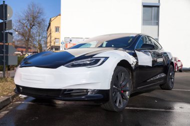 FUERTH / GERMANY - MARCH 4, 2018: Tesla logo on a Tesla car Tesla, Inc. is an American company that specializes in electric automotives, energy storage and solar panel manufacturing. clipart