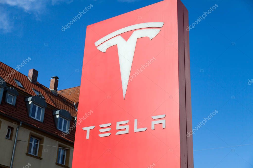 FUERTH / GERMANY - MARCH 4, 2018: Tesla logo near a car dealer. Tesla, Inc. is an American company that specializes in electric automotives, energy storage and solar panel manufacturing.