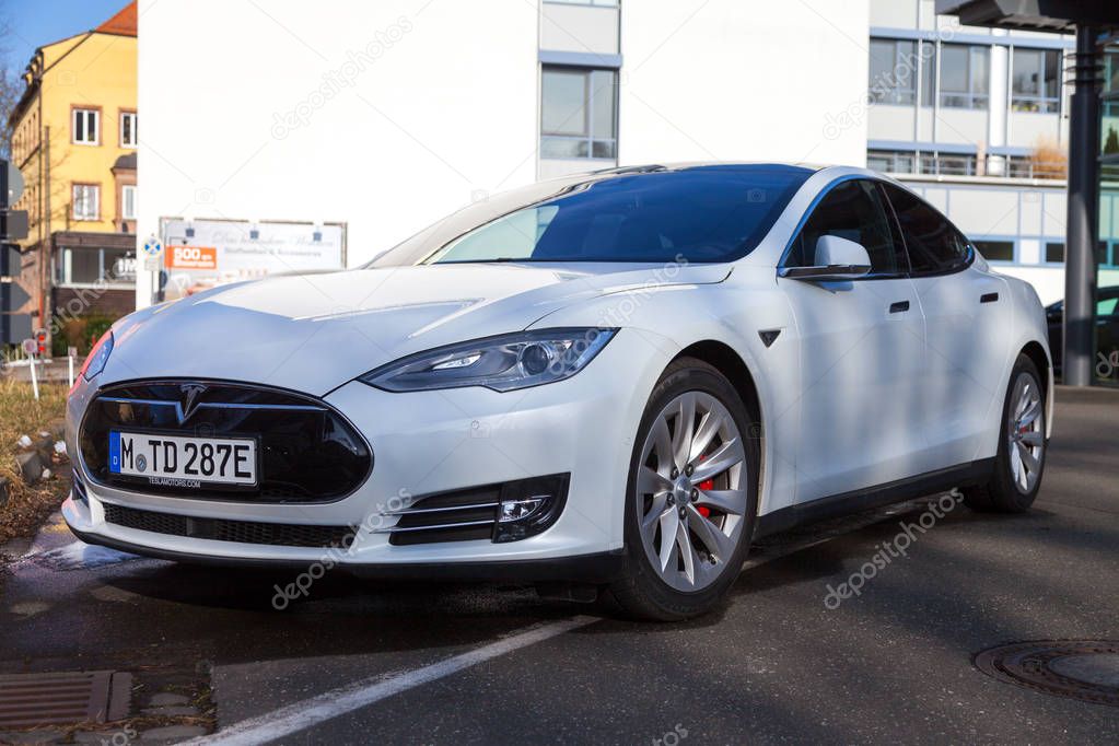 FUERTH / GERMANY - MARCH 4, 2018: Tesla logo on a Tesla car Tesla, Inc. is an American company that specializes in electric automotives, energy storage and solar panel manufacturing.