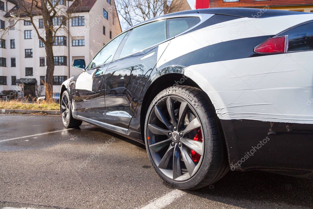 FUERTH / GERMANY - MARCH 4, 2018: Tesla logo on a Tesla car Tesla, Inc. is an American company that specializes in electric automotives, energy storage and solar panel manufacturing.