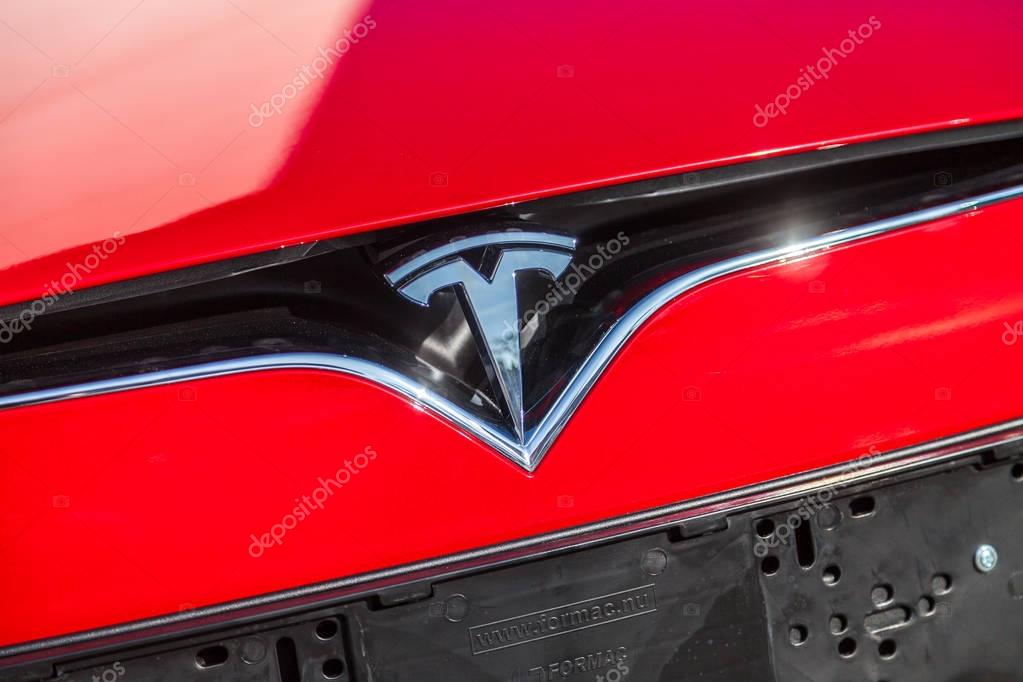FUERTH / GERMANY - MARCH 4, 2018: Tesla logo on a Tesla car Tesla, Inc. is an American company that specializes in electric automotives, energy storage and solar panel manufacturing.