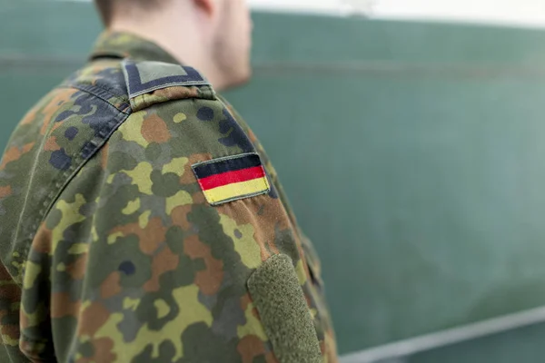 German soldier stands in a classroom . German word Bundeswehr, means german army.