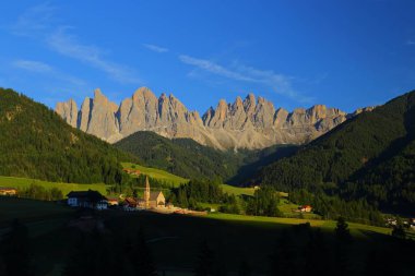 Santa Magdalena village in front of Dolomites Group, Val di Funes, Italy,  clipart