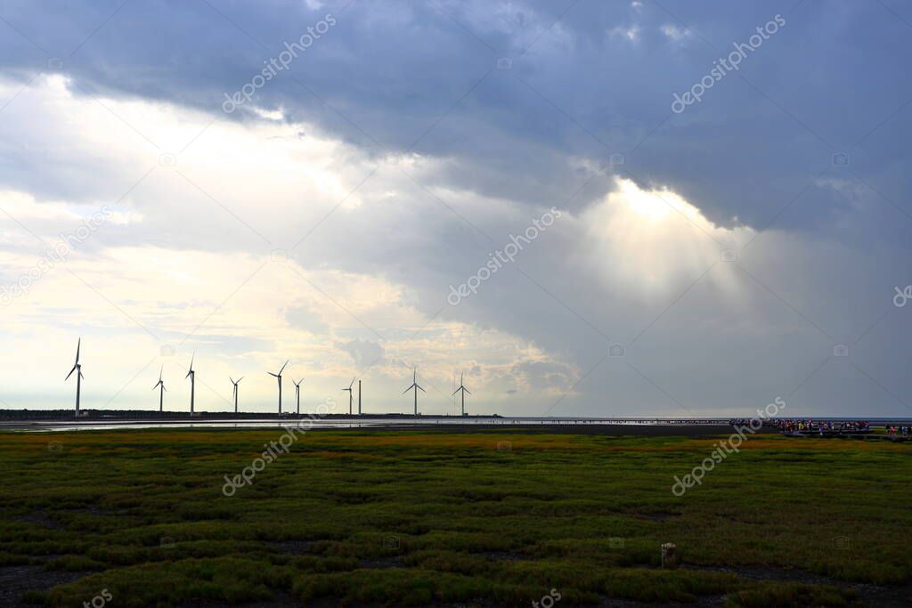 Gaomei wetlands during sunset with wind turbine background in Taiwan Taichung, 