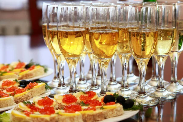 Sanduíches com caviar vermelho e champanhe na mesa — Fotografia de Stock