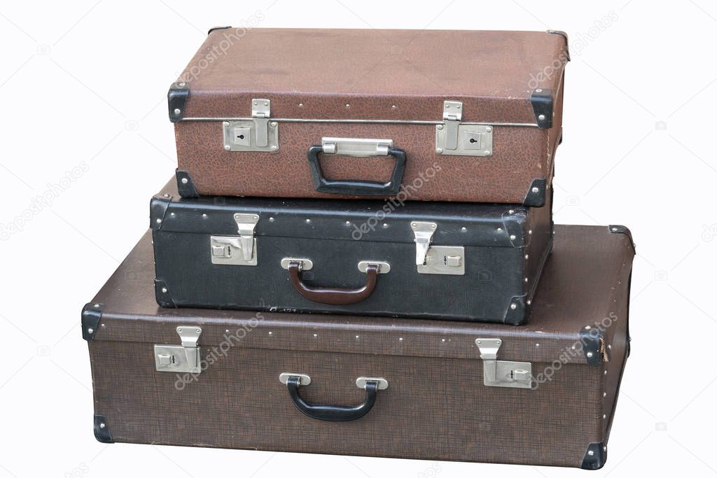 old vintage suitcases stacked isolated on white background