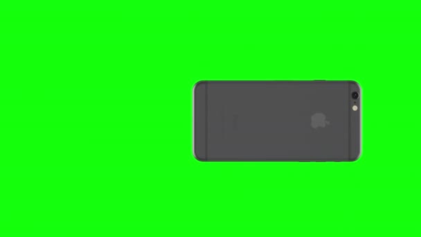 Teléfono de plata girando sobre fondo verde — Vídeos de Stock