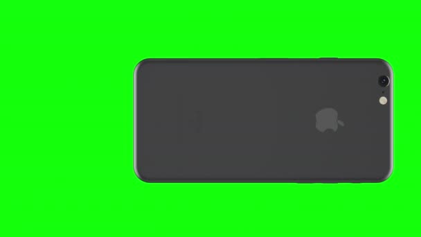 Silbernes Telefon dreht sich auf grünem Hintergrund — Stockvideo