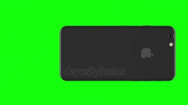 Alan gri telefon yeşil arka plan üzerinde döner.