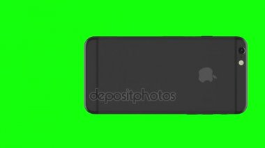 Alan gri telefon yeşil arka plan üzerinde döner.