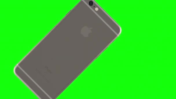 Zilveren telefoon draaien op groene achtergrond — Stockvideo