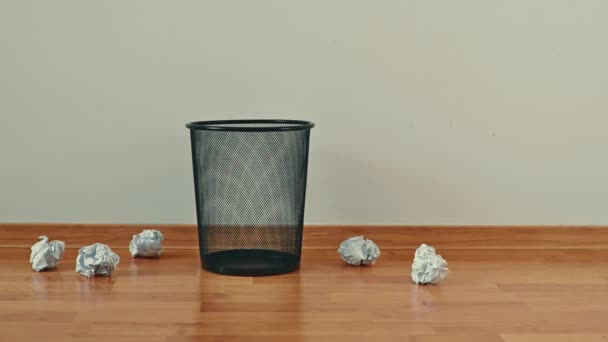 Throwing away unwanted paper in an empty trash can in the office. — Stock Video