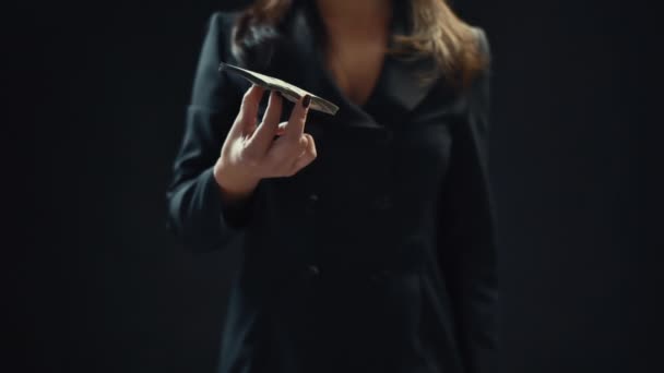 Close up, young woman businessman throwing money up, on black background. Slow motion. — Stock Video