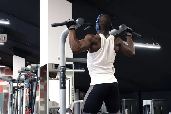 Negro hombre haciendo ejercicios pull ups — Foto de Stock