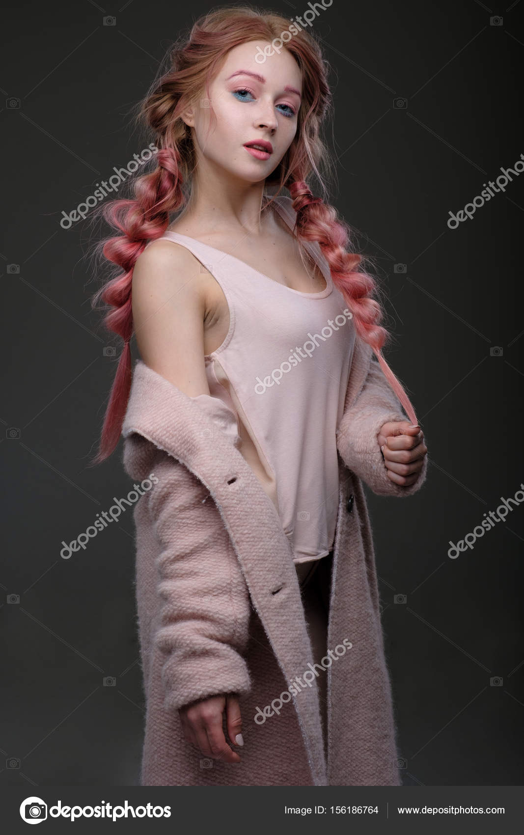 The Girl With Pink Hair In Braids And Pink Blue Makeup With A