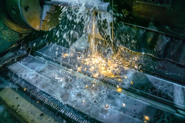 Grinding machine for metal processing with abrasive tools in production with cooling and sparks. — Stock Photo, Image