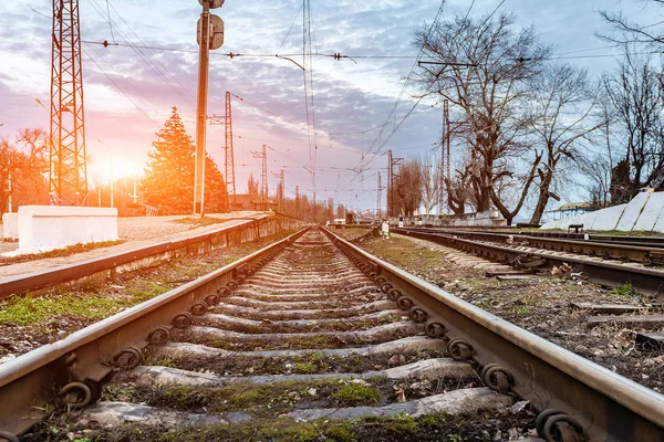 Railway road, rails and tracks going into the distance of evening sunset. Royalty Free Stock Photos