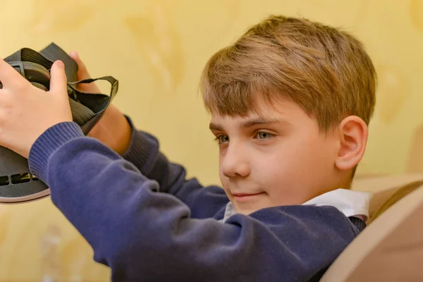 A child removes VR glasses after watching a 3D video — 스톡 사진