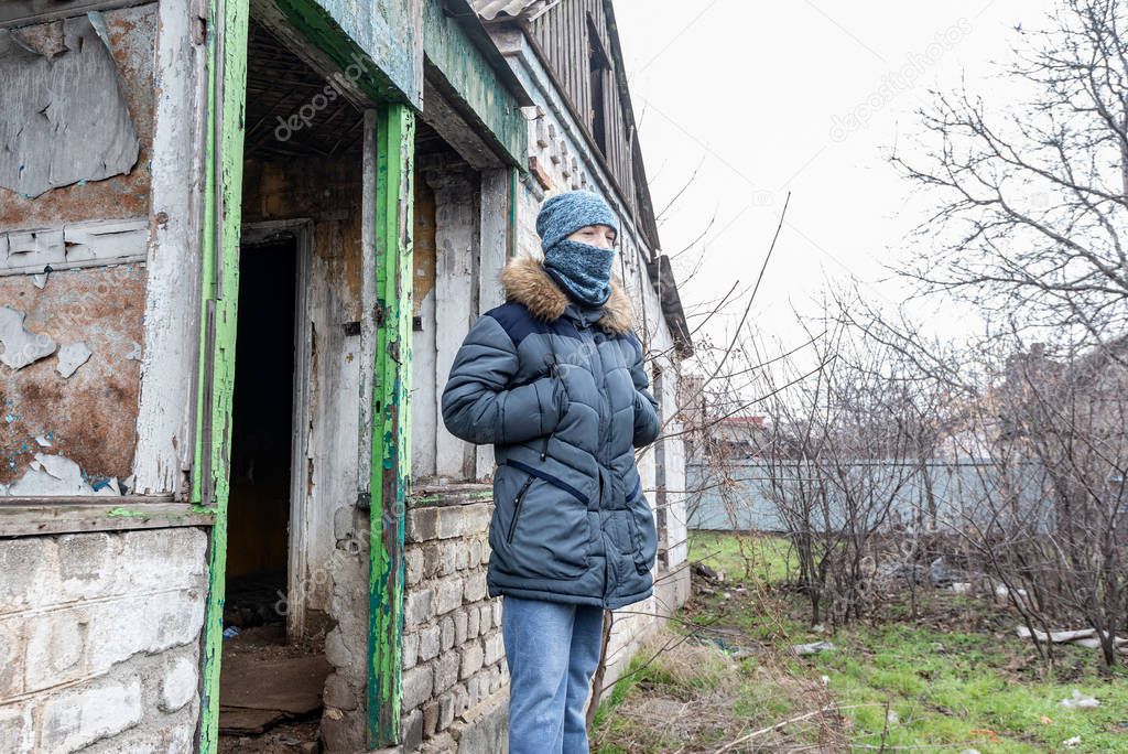 A boy in a ruined house, a teenager was left homeless as a result of military conflicts and natural disasters.