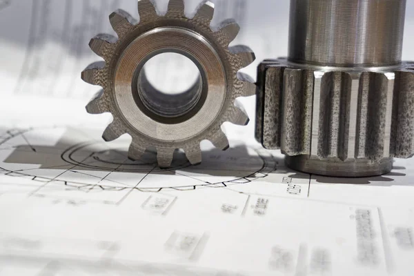 The gear after manufacturing on the gear cutter lies on the technical drawing. — Stok fotoğraf