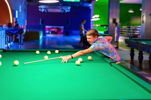 Boy Plays Billiards Hits Ball Cue Driving Him Pocket Green — Stock Photo, Image