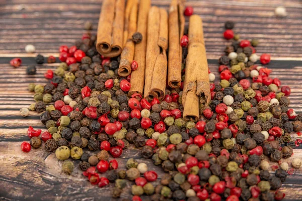 Cinnamon and spices in bulk lie on a dark wooden background