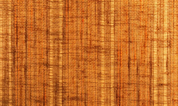 Närbild av en textil yta med orange och brun färg — Stockfoto