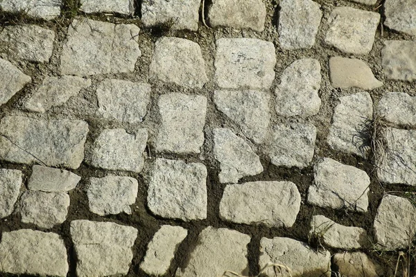 Texture of a cobblestone ground with wet parts — Stock Photo, Image
