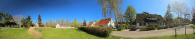 Panoramic image of historic group of houses, listed as monuments in Riems near Greifswald clipart