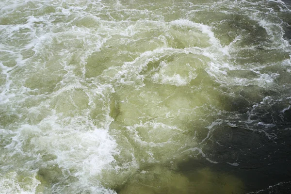 The rapid flow of water foams and boils. Vertiginous current. Dangerous concept.
