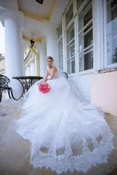 Nevěsta ve svatebních šatech s kyticí — Stock fotografie