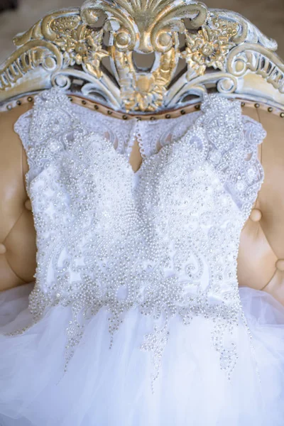 Beautiful white wedding dress for bride indoors on the bed