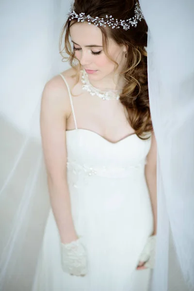 Brunette bride in fashion white wedding dress with makeup